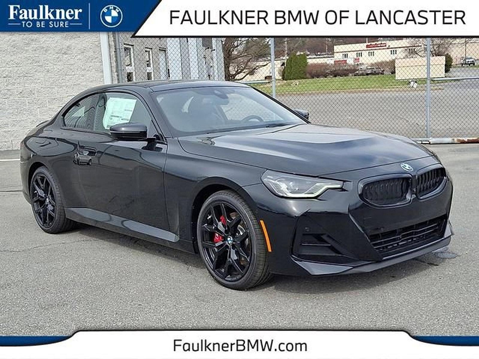 2026 BMW 230i xDrive Coupe in Black Sapphire Metallic — front three-quarter view