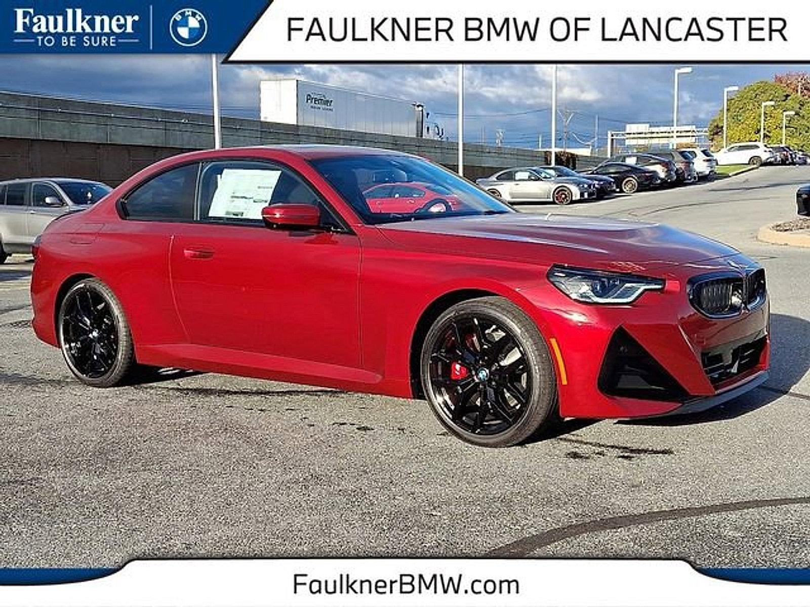 2026 BMW 230i xDrive Coupe in Vegas Red Metallic — front three-quarter view